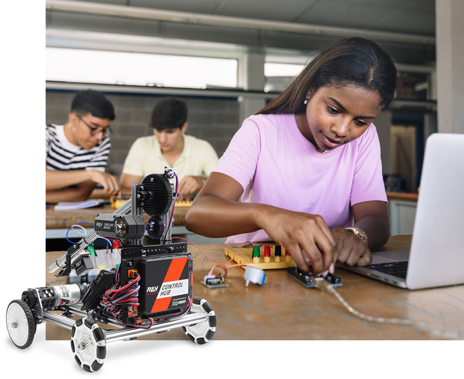 middle school students programming robots while working on a project based lesson